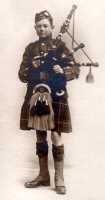 1915 Ross in his Scout uniform with bagpipes.